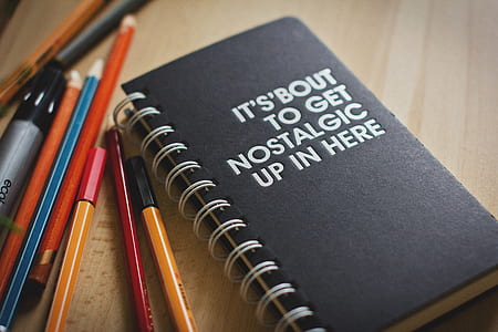 black notebook beside pencils thumbnail