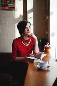woman in red dress shirt sitting near desk thumbnail