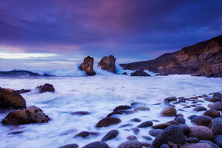 rock formation near body of water thumbnail