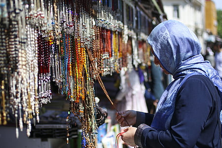 woman holding praying beads thumbnail