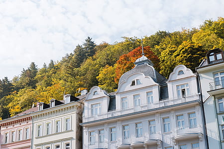 Tall hotels and traditional buildings on sunny street in Karlovy Vary thumbnail