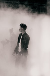 man in black jacket covered with smoke thumbnail