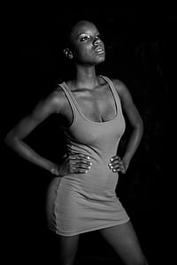 woman wearing gray scoop-neck sleeveless mini dress holding her waist thumbnail