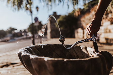 Drinking fountain with stream of water on the sidewalk thumbnail