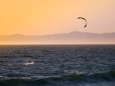person kite surfing at sunset thumbnail