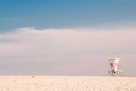 landscape photography of lifeguard tower on sand thumbnail