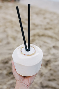 Female holding a fresh coconut thumbnail