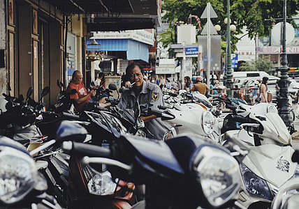 photo of man standing in front of motorcycle thumbnail