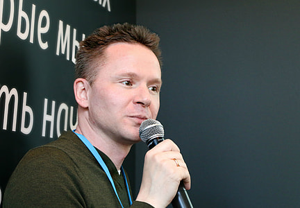 photo of a man holding black microphone thumbnail