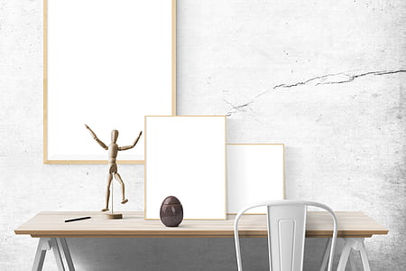 white framed and action figure on table thumbnail