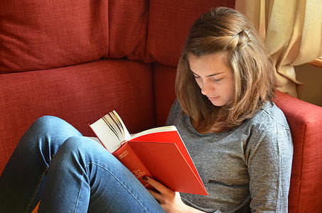 woman reading book on couch thumbnail