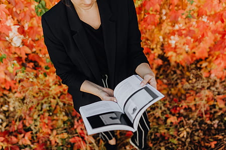 Girl with the Grafconf book on the background of colourful leaves thumbnail