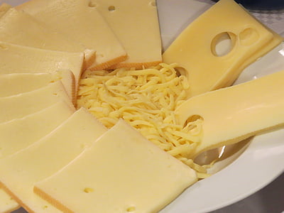 sliced and grated cheese on round white ceramic bowl thumbnail