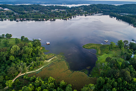 aerial photography of body of water near trees thumbnail