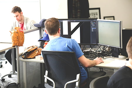 man using computer inside room thumbnail