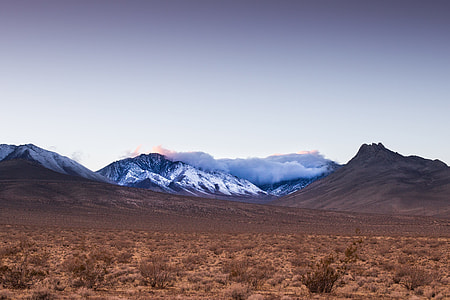 snowy mountains under cloudy sky thumbnail