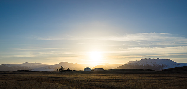 landscape photography of field under blue sky thumbnail