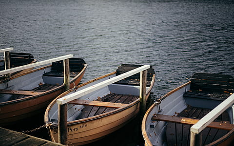 four brown wooden canoes thumbnail