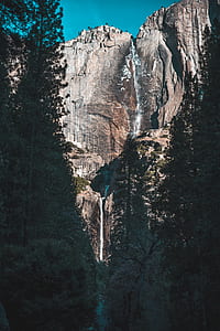 waterfalls in the middle of stones during daytime thumbnail