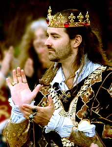 man in black and gold suit and gold crown thumbnail