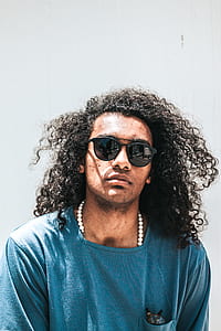 man in green shirt and black sunglasses thumbnail