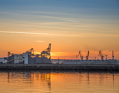 concrete buildings near body of water at sunset thumbnail