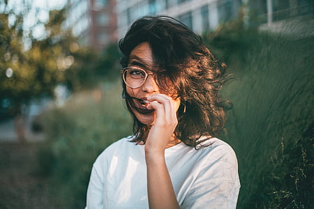 woman posing beside leaves thumbnail