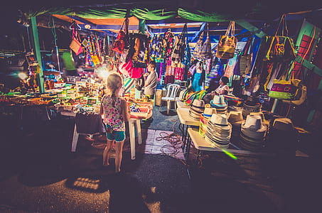 children standing in front of store during nighttime thumbnail