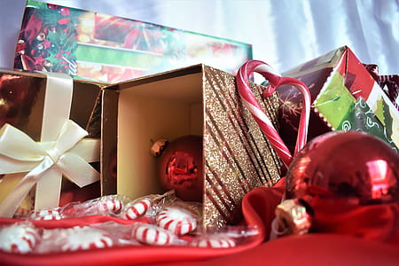 Christmas bauble and cane stick on red surface thumbnail
