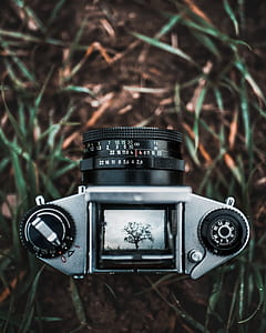 shallow focus photography of film camera on grass thumbnail