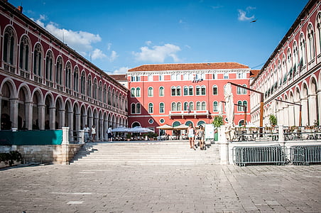 group of people walking on stairs between building thumbnail