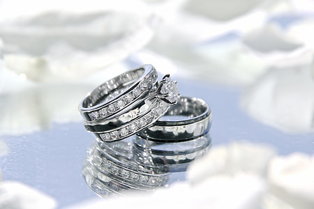 silver-colored bridal ring set on glass surface thumbnail