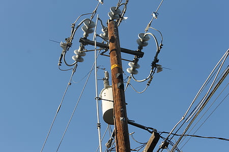 brown and black electric post under clear blue sky thumbnail