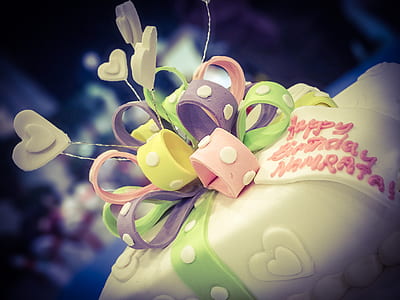 pink, green, white, and purple icing-covered cake thumbnail