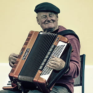 Man Sitting Playing Accordion thumbnail