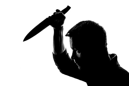man in black collared shirt holding knife thumbnail