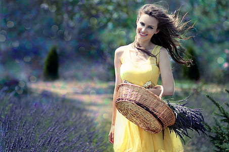 woman in yellow sleeveless dress carrying brown basket thumbnail