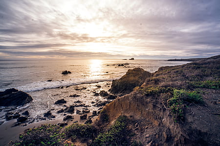rock formations near body of water thumbnail