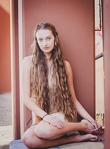 woman wearing dress sitting on floor near the wall thumbnail