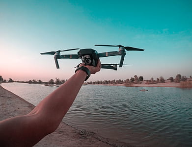 Photo of a Person Holding a Drone thumbnail