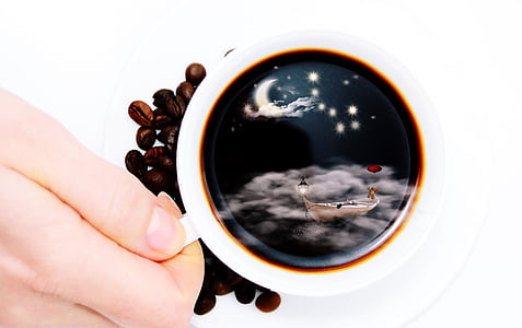 white ceramic mug filled with coffee beside coffee beans thumbnail