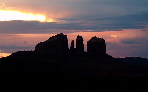 sunset silhouette of rock formation thumbnail