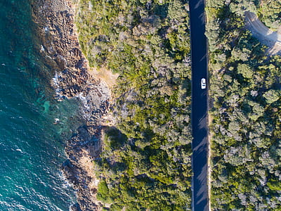 aerial view of a car traveling on black road thumbnail