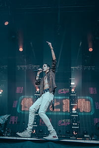 man holding microphone on stage thumbnail
