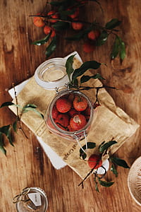round red fruits in a jar on top of table thumbnail