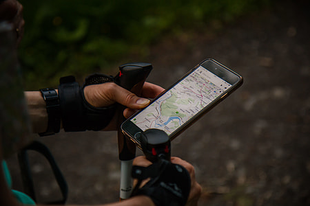 person holding black iPhone 7 displaying map application thumbnail
