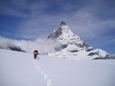 person climbing snowy mountain thumbnail