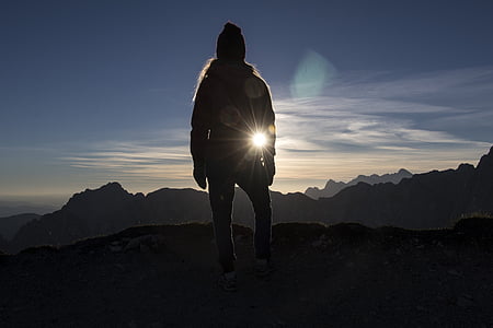 silhoutte of man on rock formation thumbnail