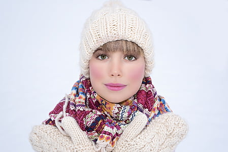woman in white jacket wearing knit beanie and floral scarf thumbnail