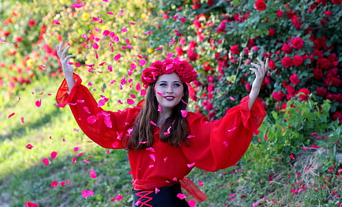 woman wearing red rose crown showering petals thumbnail